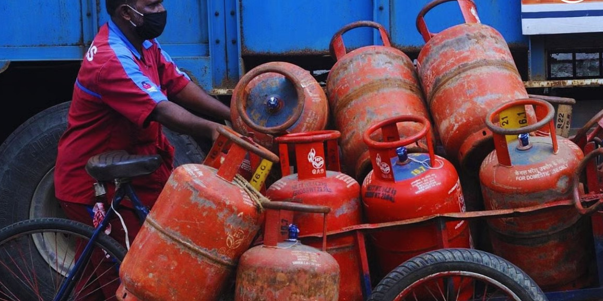 Commercial LPG Price Cut: delivery worker loads cylinders in India