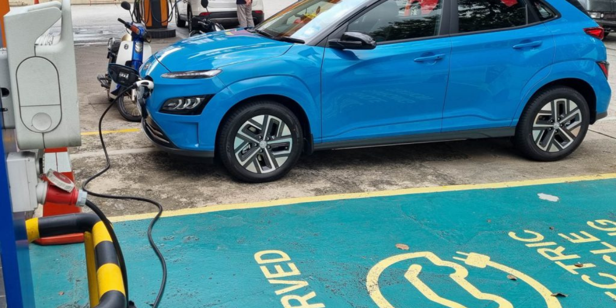 Malaysia EV Levy Mechanism Still Under Review, Says MITI Minister 1 Malaysia EV levy , blue Hyundai Kona Electric charging at a reserved EV station